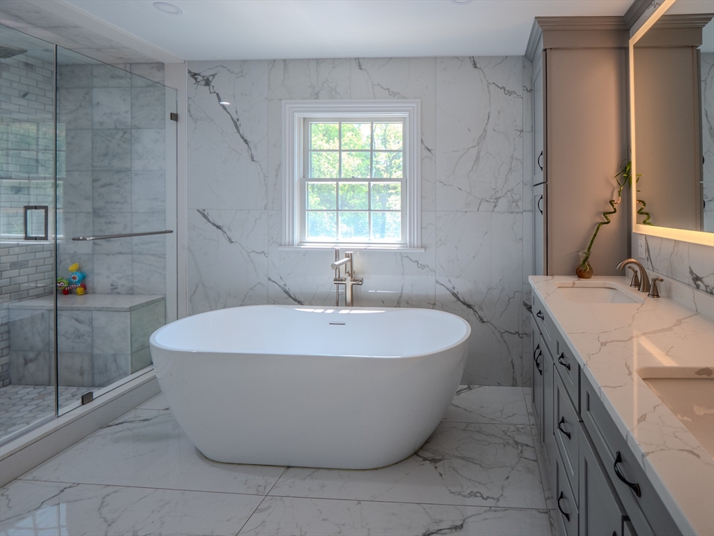 159 Mishawum Road Woburn, MA 01801 - Photo 15 of 41 a large tub sitting in a bathroom next to a window