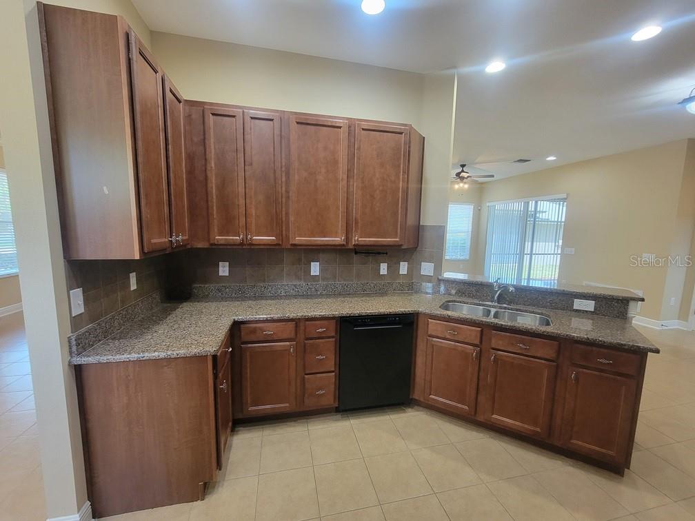 10418 Fenceline Road New Port Richey, FL 34655 - Photo 14 of 36 a kitchen with a sink and a cabinets