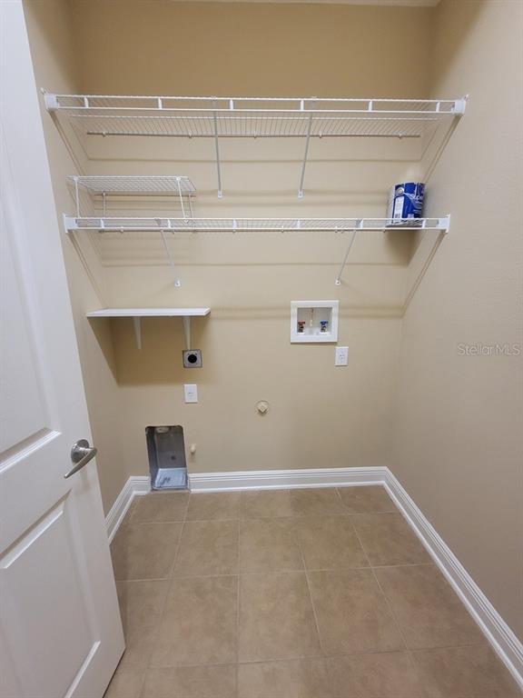 10418 Fenceline Road New Port Richey, FL 34655 - Photo 16 of 36 a view of storage and utility room with racks on the wall