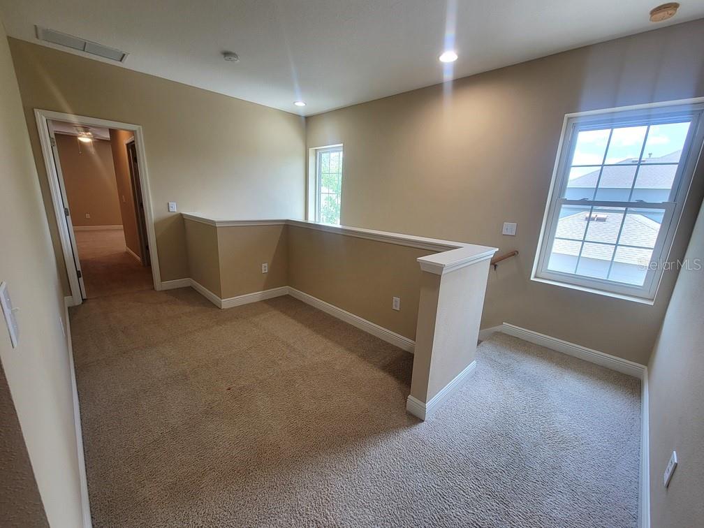 10418 Fenceline Road New Port Richey, FL 34655 - Photo 18 of 36 an empty room with windows and closet