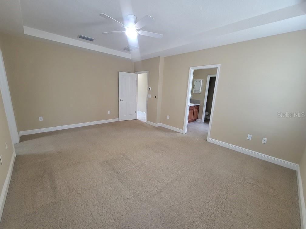 10418 Fenceline Road New Port Richey, FL 34655 - Photo 24 of 36 an empty room with a ceiling fan and a window