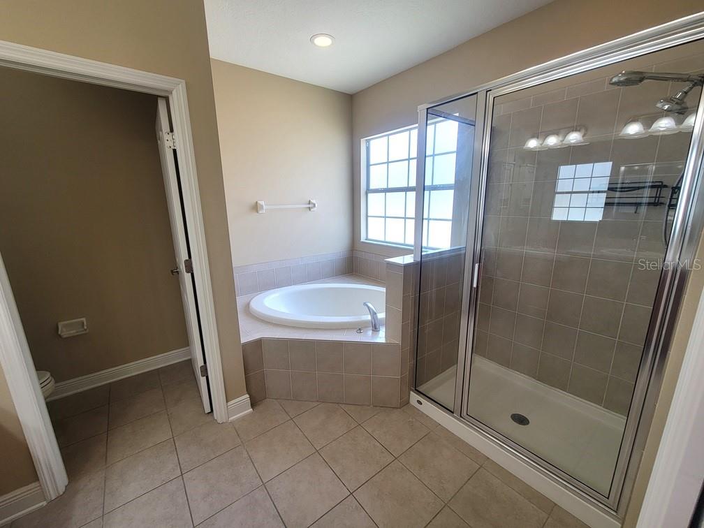 10418 Fenceline Road New Port Richey, FL 34655 - Photo 27 of 36 a bathroom with a shower and a sink