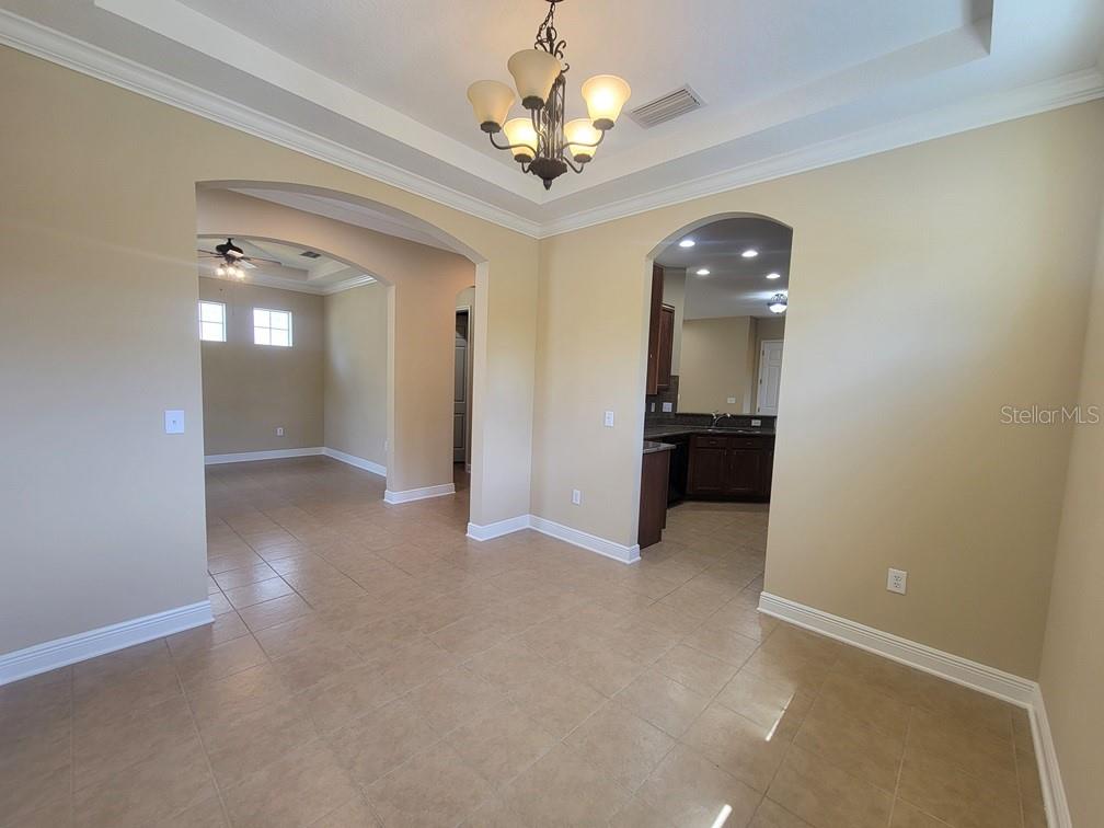 10418 Fenceline Road New Port Richey, FL 34655 - Photo 7 of 36 en view of a hallway with chandelier