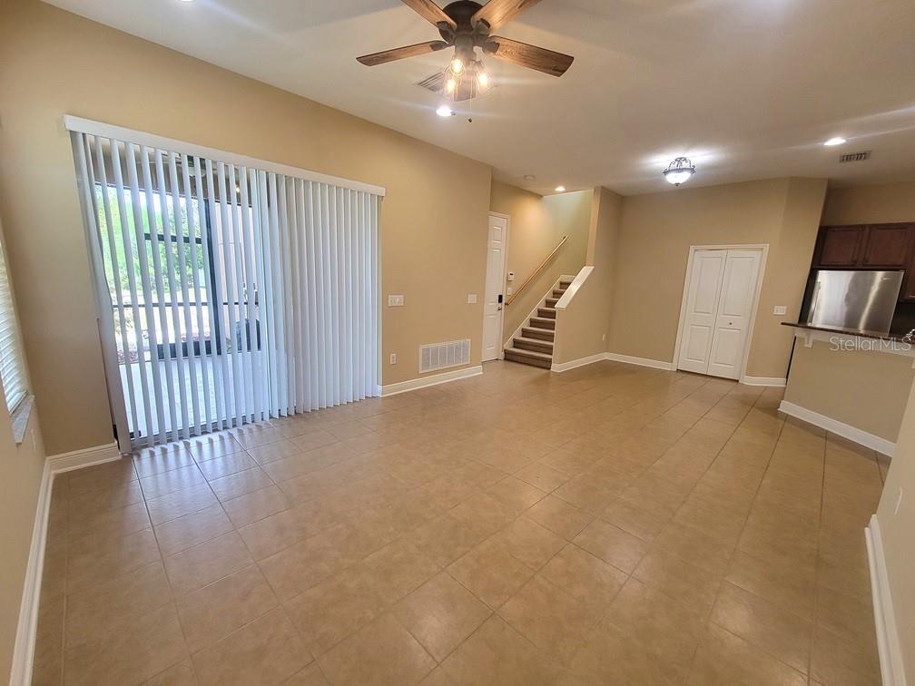 10418 Fenceline Road New Port Richey, FL 34655 - Photo 10 of 36 an empty room with wooden floor fan and windows