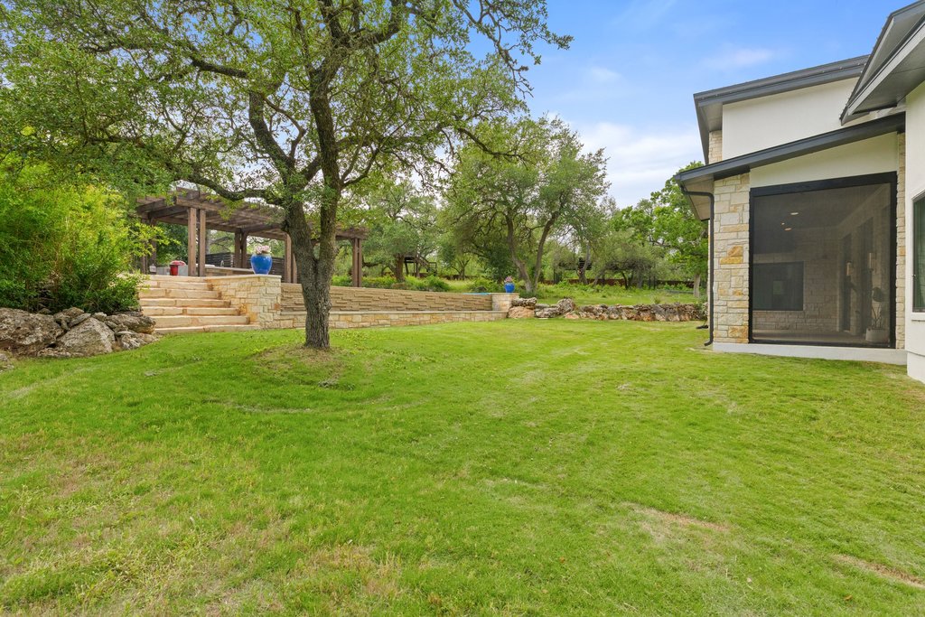 11002 Foundation Road Austin, TX 78726 - Photo 32 of 40 a view of a house with backyard and a tree