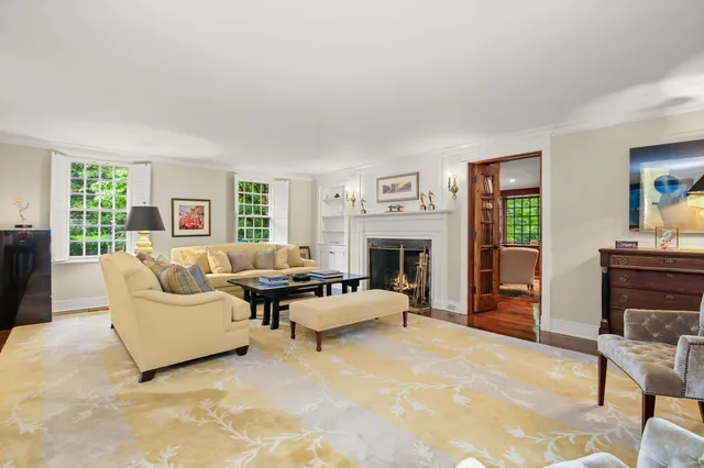 a dining room with furniture a chandelier and wooden floor