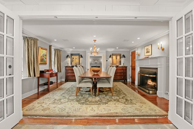 a view of a dining room with furniture wooden floor and chandelier