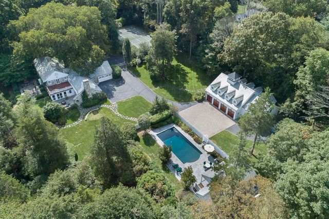 an aerial view of a house with a yard and outdoor seating