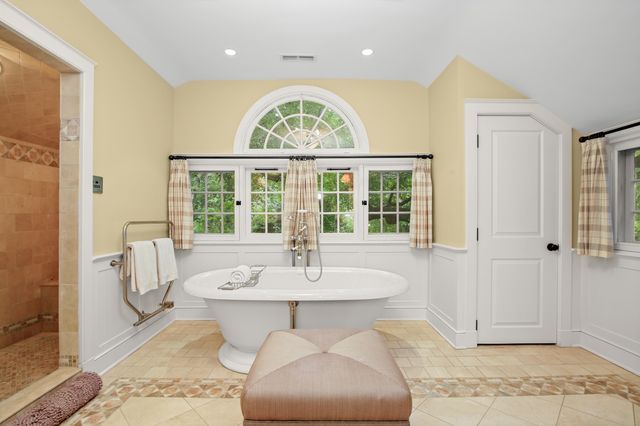 a bedroom with a bed and large window