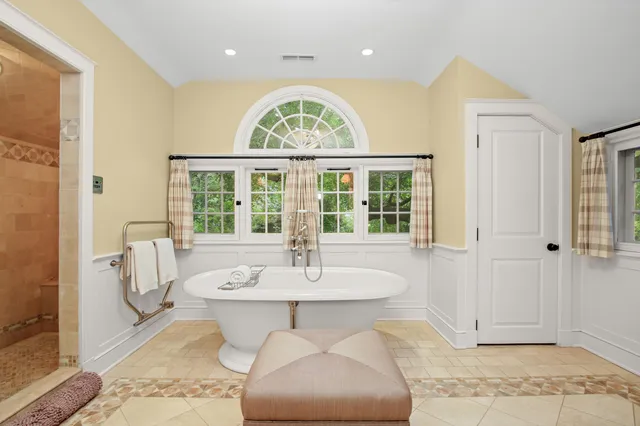 a bedroom with a bed and large window