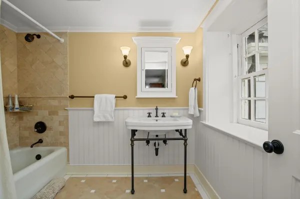 a bathroom with a granite countertop sink a mirror and a shower