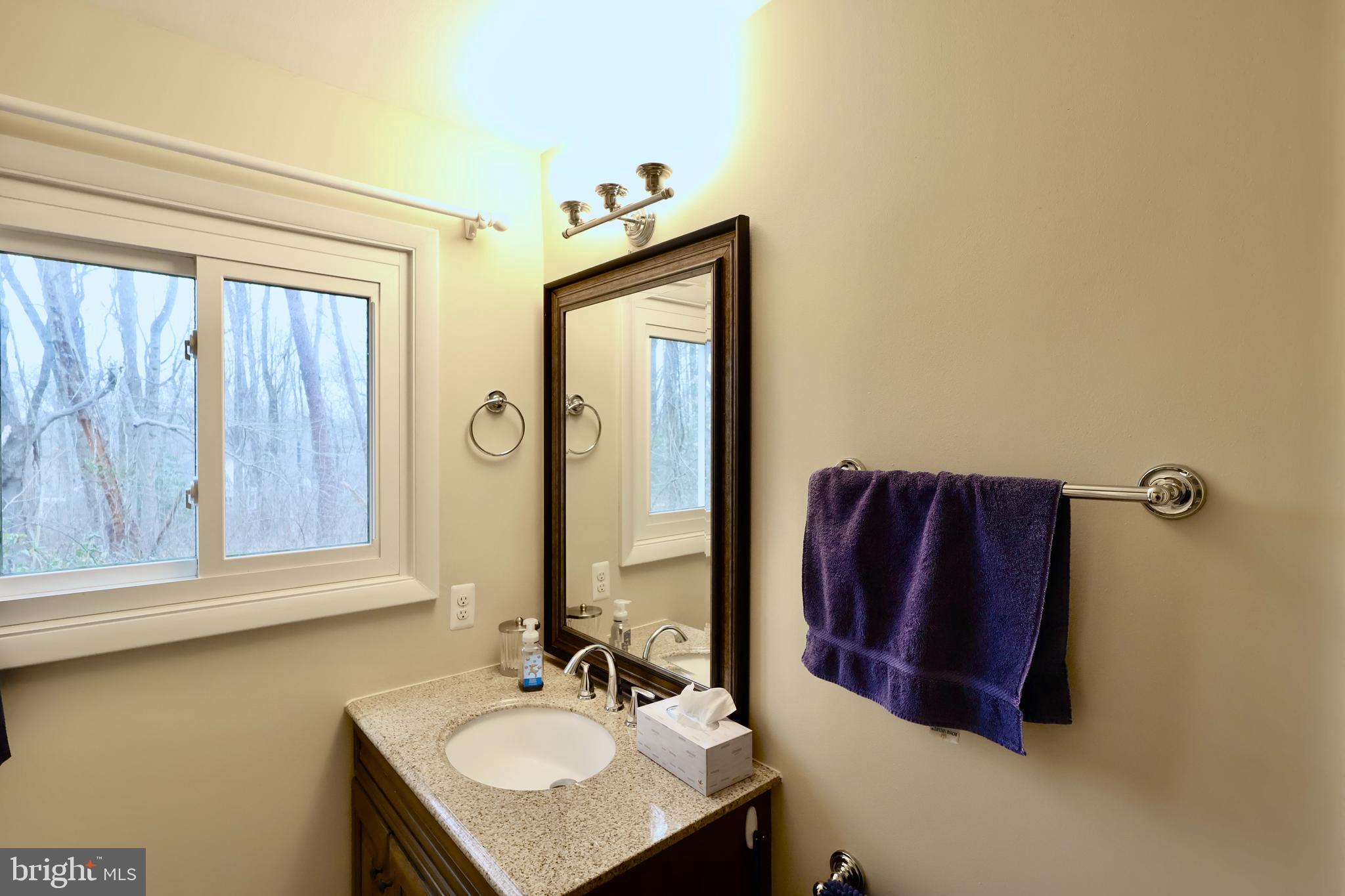 13040 Wainwright Road Highland, MD 20777 - Photo 31 of 34 a bathroom with a sink vanity mirror and a