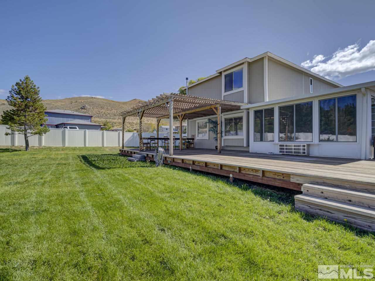 17175 Waxwing Street Reno, NV 89508 - Photo 4 of 25 a front view of a house with swimming pool having outdoor seating