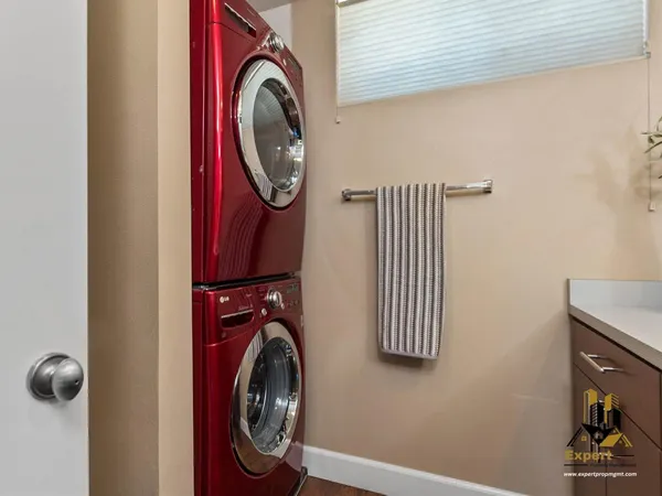 a view of a storage and utility room with washer and dryer