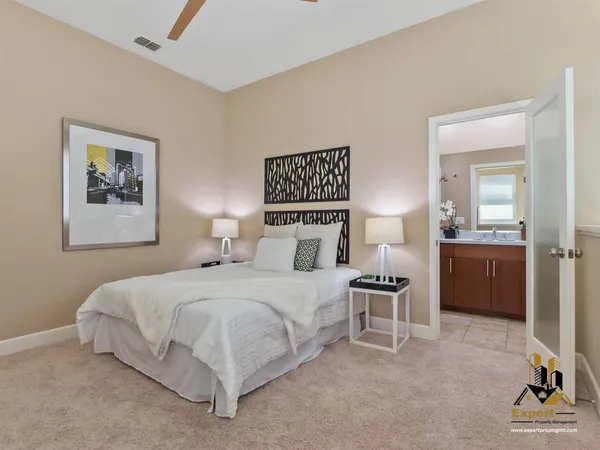 a bedroom with a bed and a view of kitchen