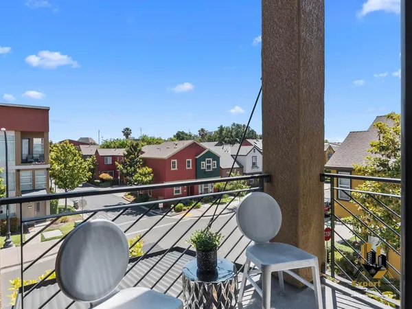 a balcony with table and chairs