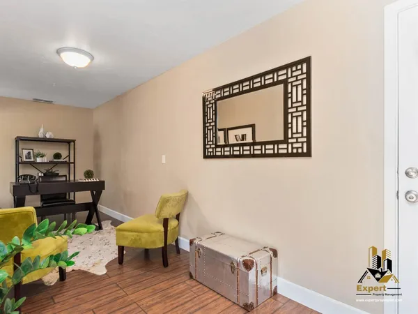 a living room with furniture and a wooden floor