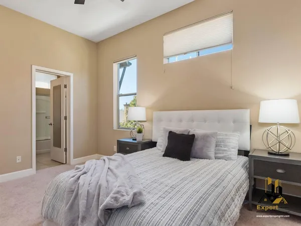 a bedroom with a bed and a lamp