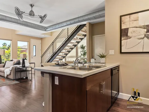 a kitchen with sink and lots of wooden furniture