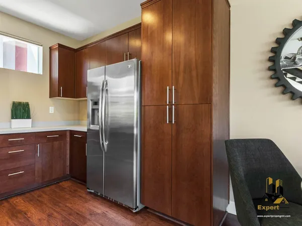 a kitchen with a refrigerator and cabinets