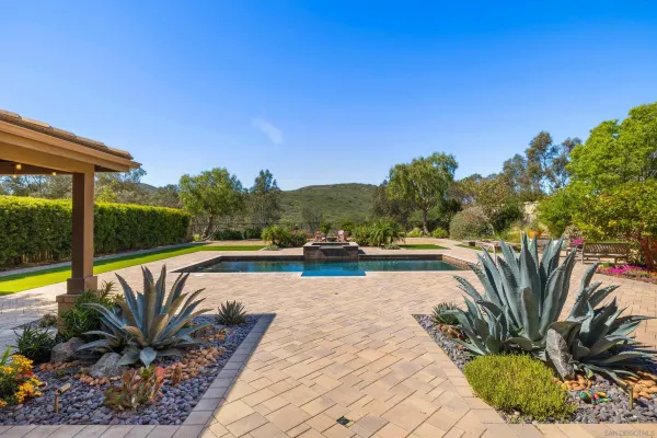 a view of swimming pool with outdoor seating and plants