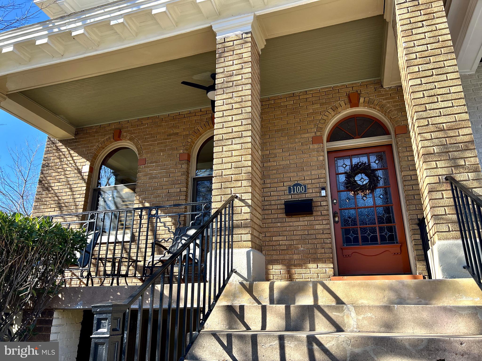 A rocking front porch overlooking s active street