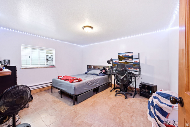 169 Taylor Road, Unit 101 Grantsville, UT 84029 - Photo 26 of 47 Main home - Bedroom featuring tile flooring, white walls, and a window with blinds