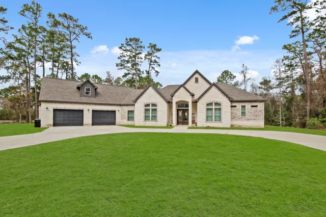 a view of a white house with a yard
