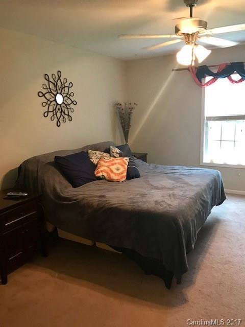 3510 Mack Ballard Road, Unit 13 Maiden, NC 28650 - Photo 13 of 24 a bedroom with a bed and a chandelier