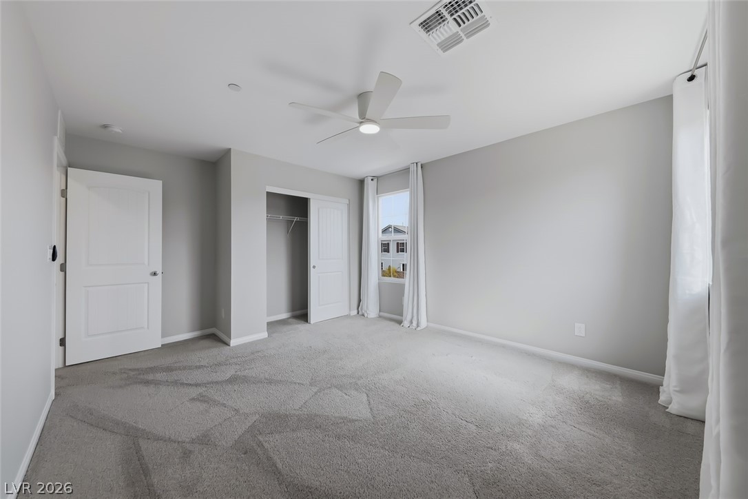 3564 Credere Lane Henderson, NV 89074 - Photo 30 of 40 Unfurnished bedroom featuring a closet, light carpet, and ceiling fan