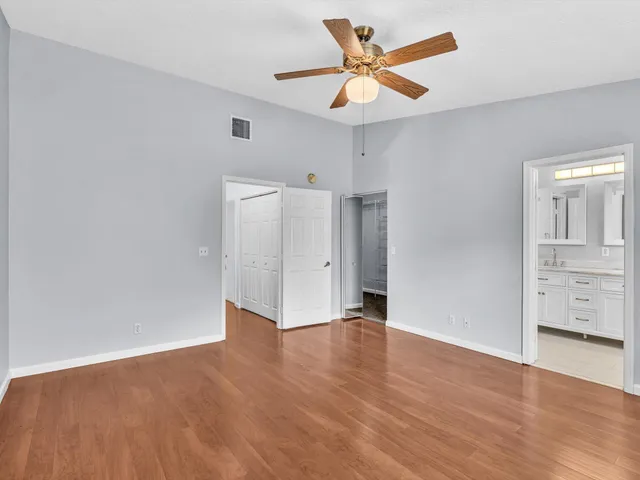 a bathroom with a granite countertop sink mirror and shower