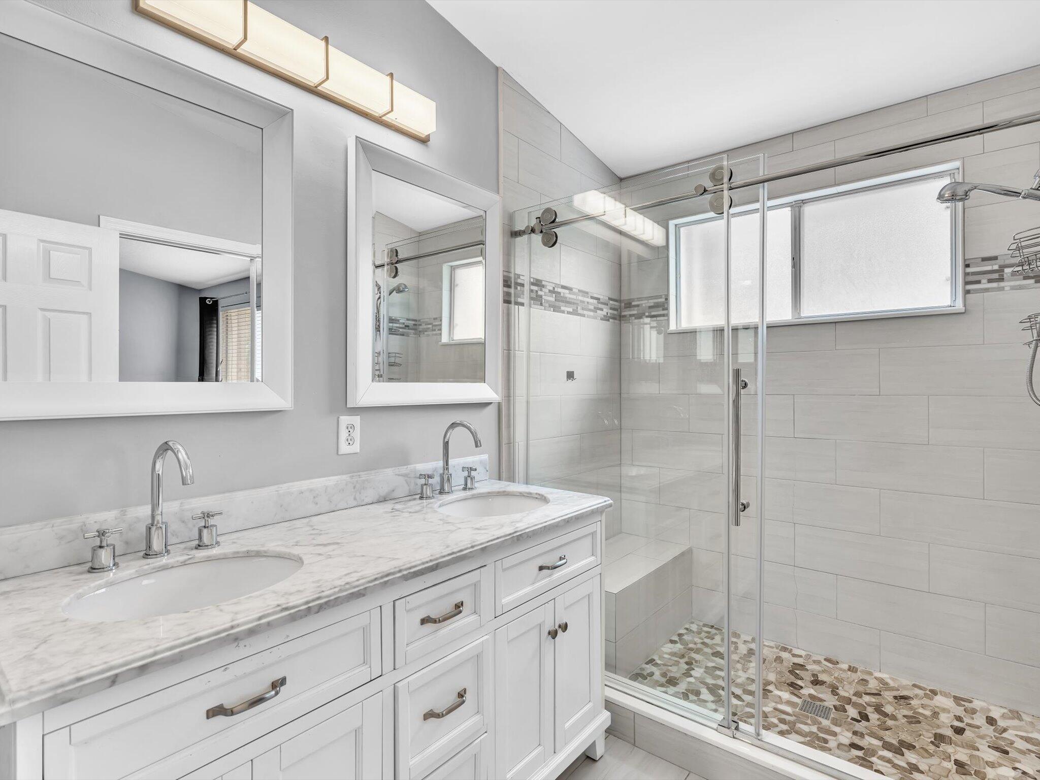 21018 Vía Eden, Unit 21018 Boca Raton, FL 33433 - Photo 19 of 63 a bathroom with a granite countertop sink mirror and shower
