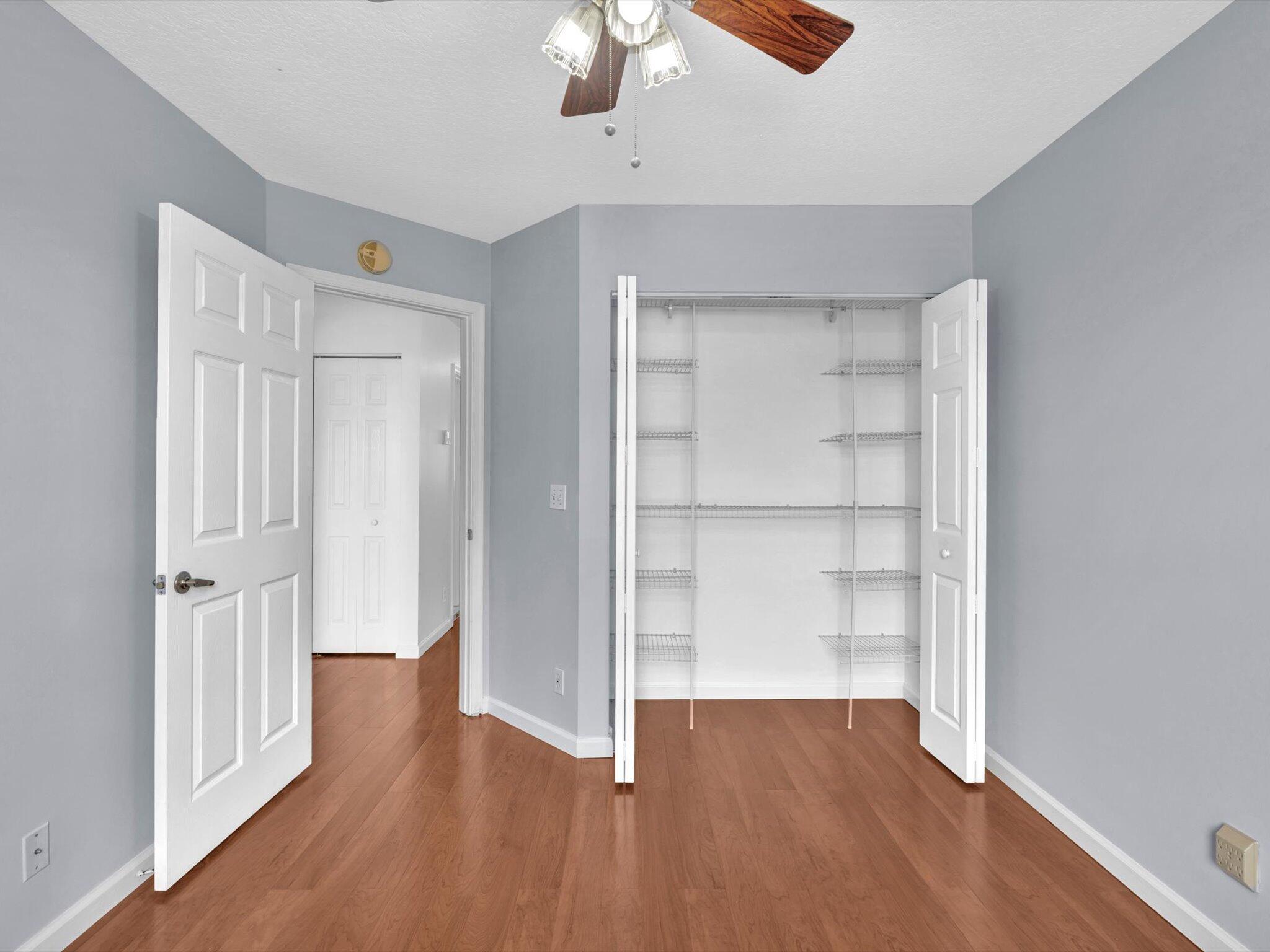 21018 Vía Eden, Unit 21018 Boca Raton, FL 33433 - Photo 24 of 63 a view of a room with wooden floor closet and windows