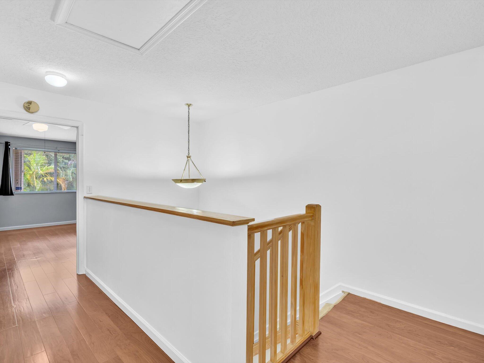 21018 Vía Eden, Unit 21018 Boca Raton, FL 33433 - Photo 26 of 63 a view of a hallway with wooden floor