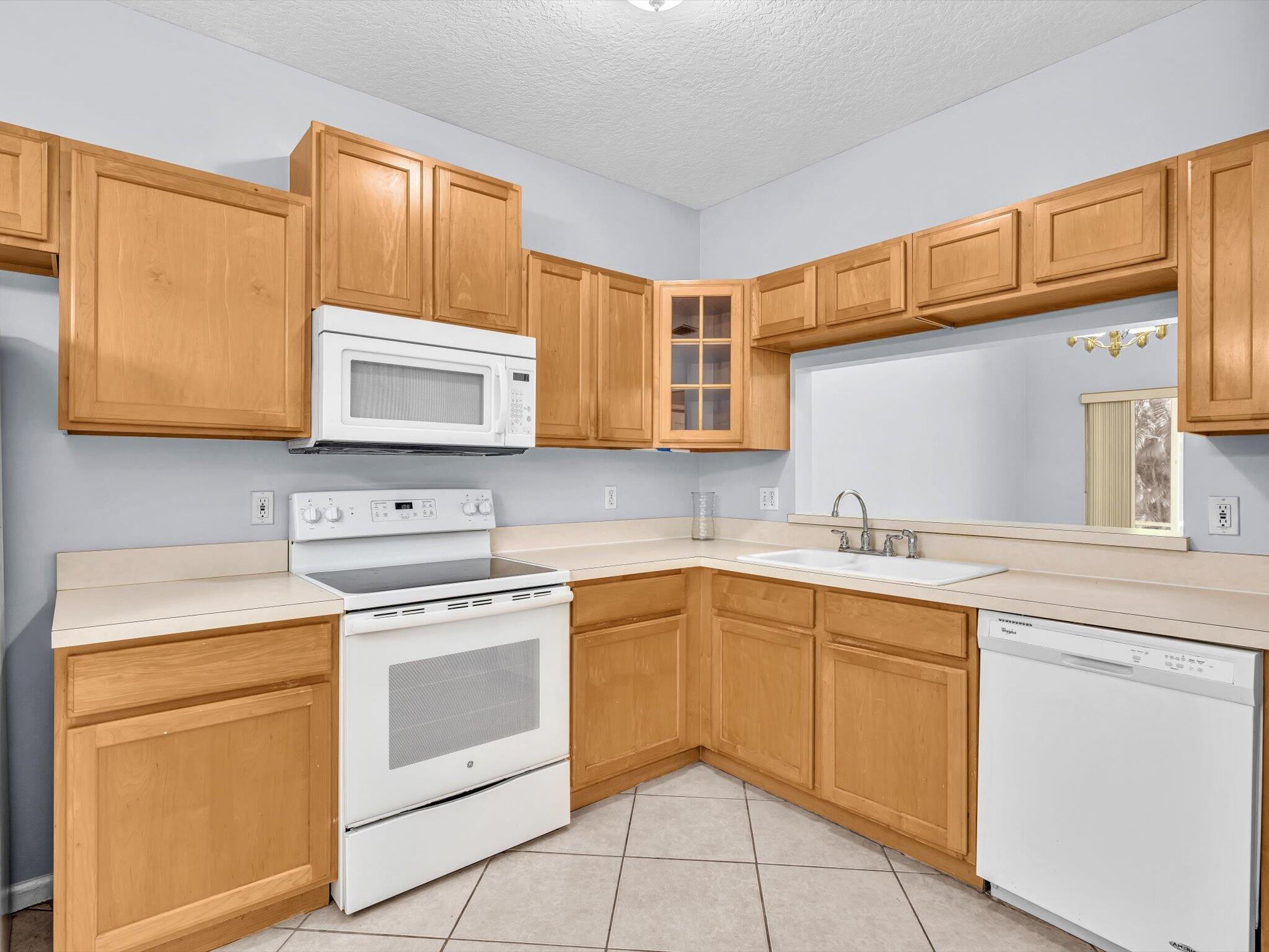 21018 Vía Eden, Unit 21018 Boca Raton, FL 33433 - Photo 3 of 63 a kitchen with a stove sink and cabinets