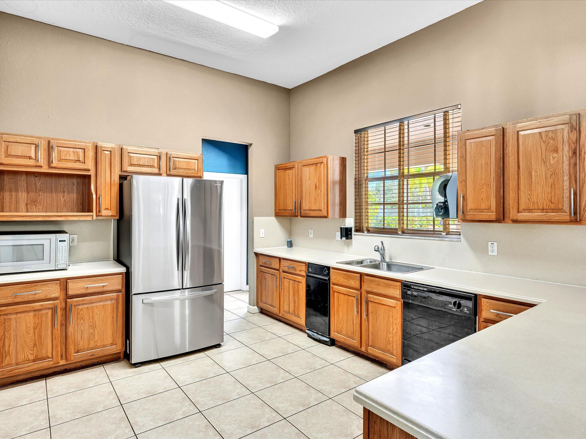 21018 Vía Eden, Unit 21018 Boca Raton, FL 33433 - Photo 44 of 63 a kitchen with granite countertop a sink stainless steel appliances and cabinets