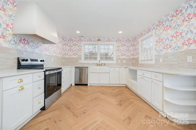 a kitchen with a sink stove and cabinets