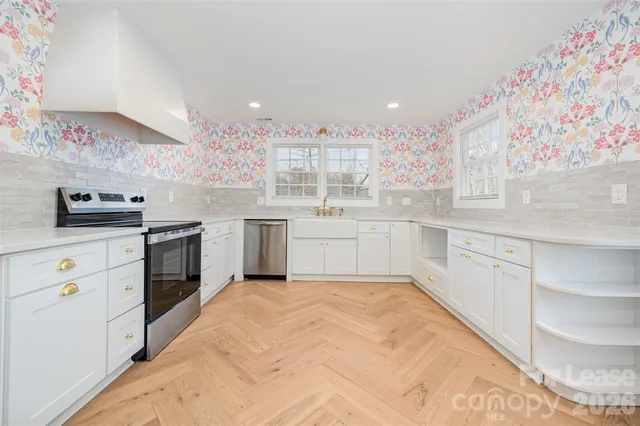 a kitchen with a sink stove and cabinets