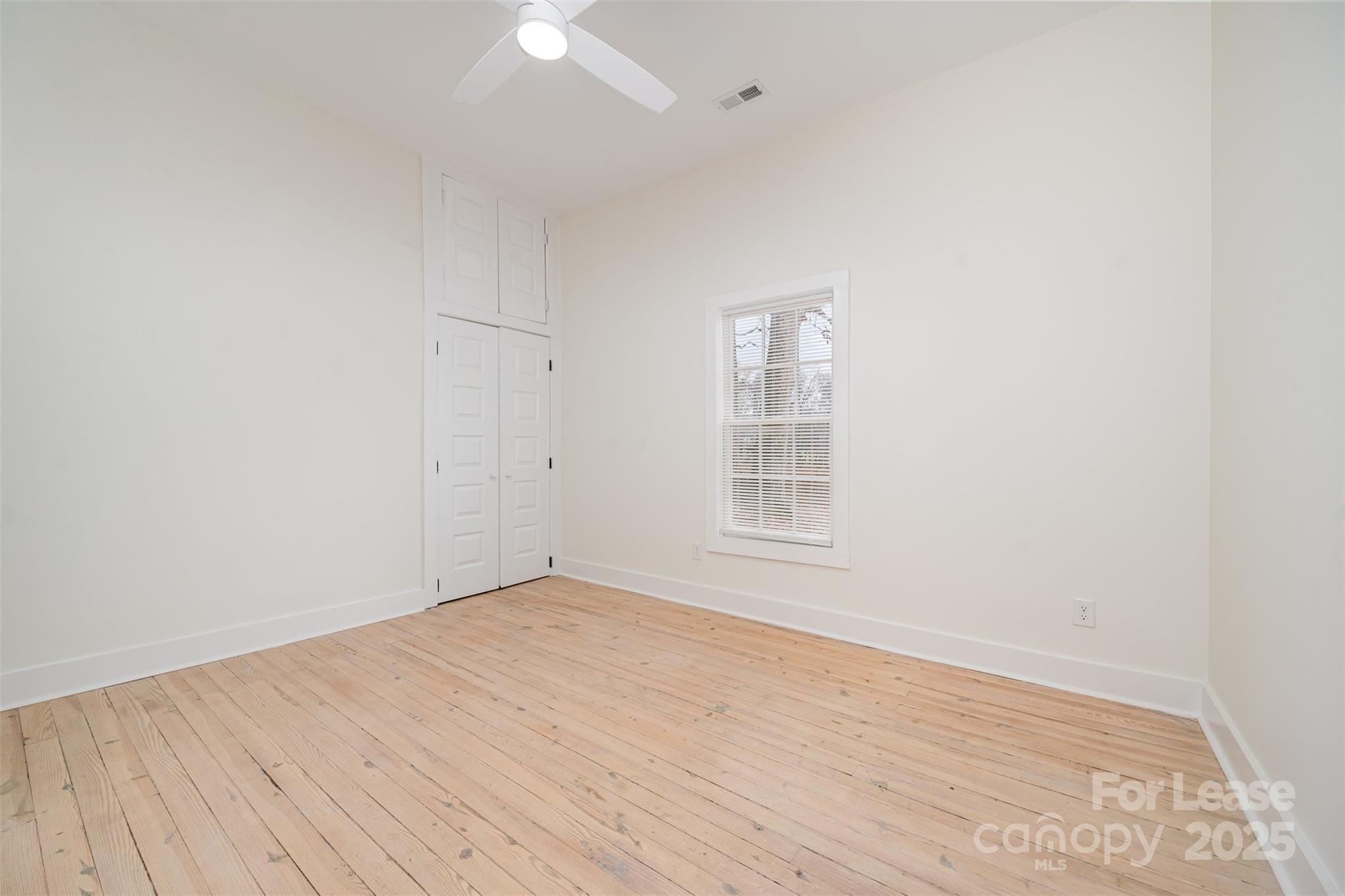 3612 East Brief Road Monroe, NC 28110 - Photo 13 of 22 an empty room with wooden floor and windows
