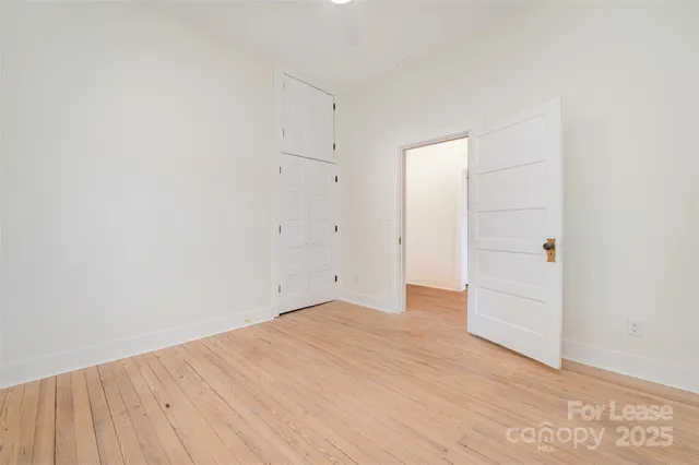 an empty room with wooden floor