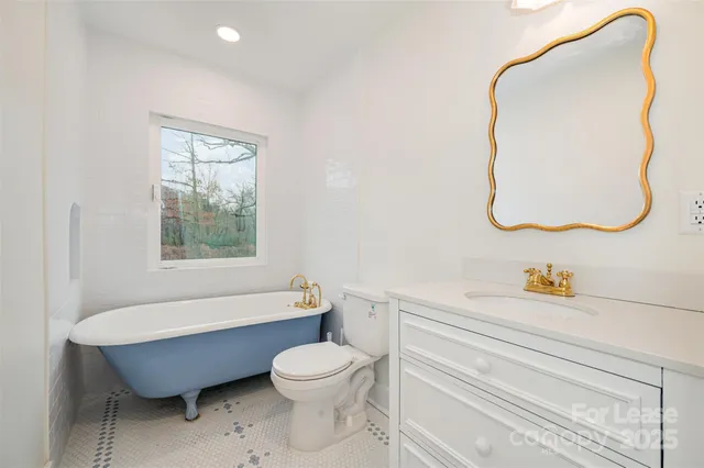 a bathroom with a toilet sink and tub