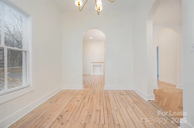 a view of a room with wooden floor and a window