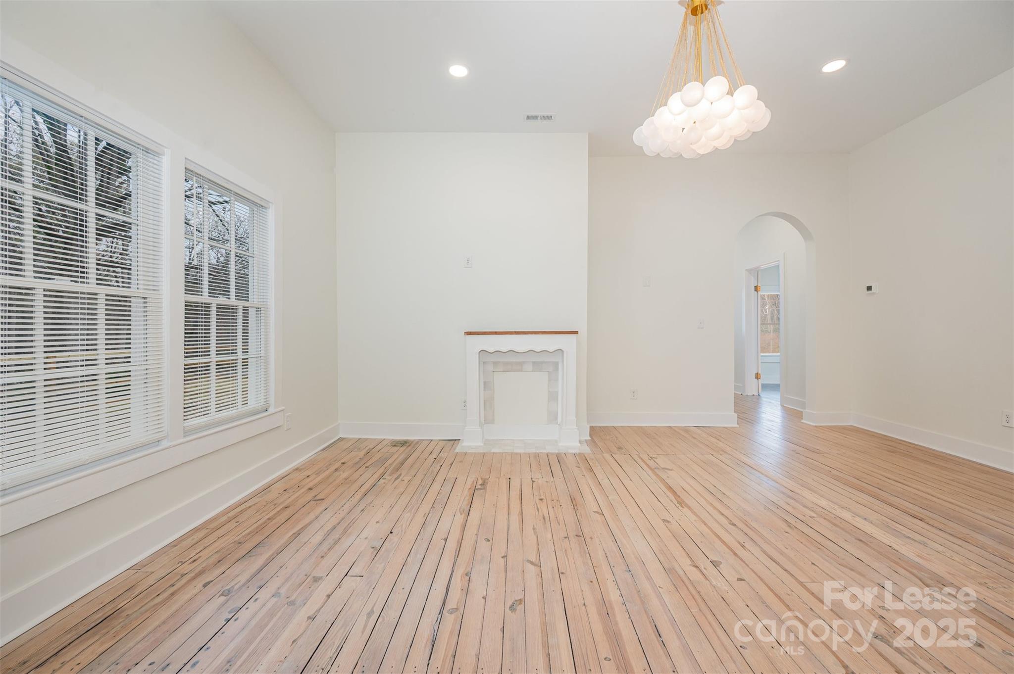 3612 East Brief Road Monroe, NC 28110 - Photo 2 of 22 wooden floor in an empty room with a window