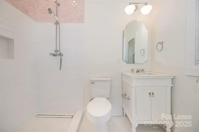 a bathroom with a toilet a sink and mirror