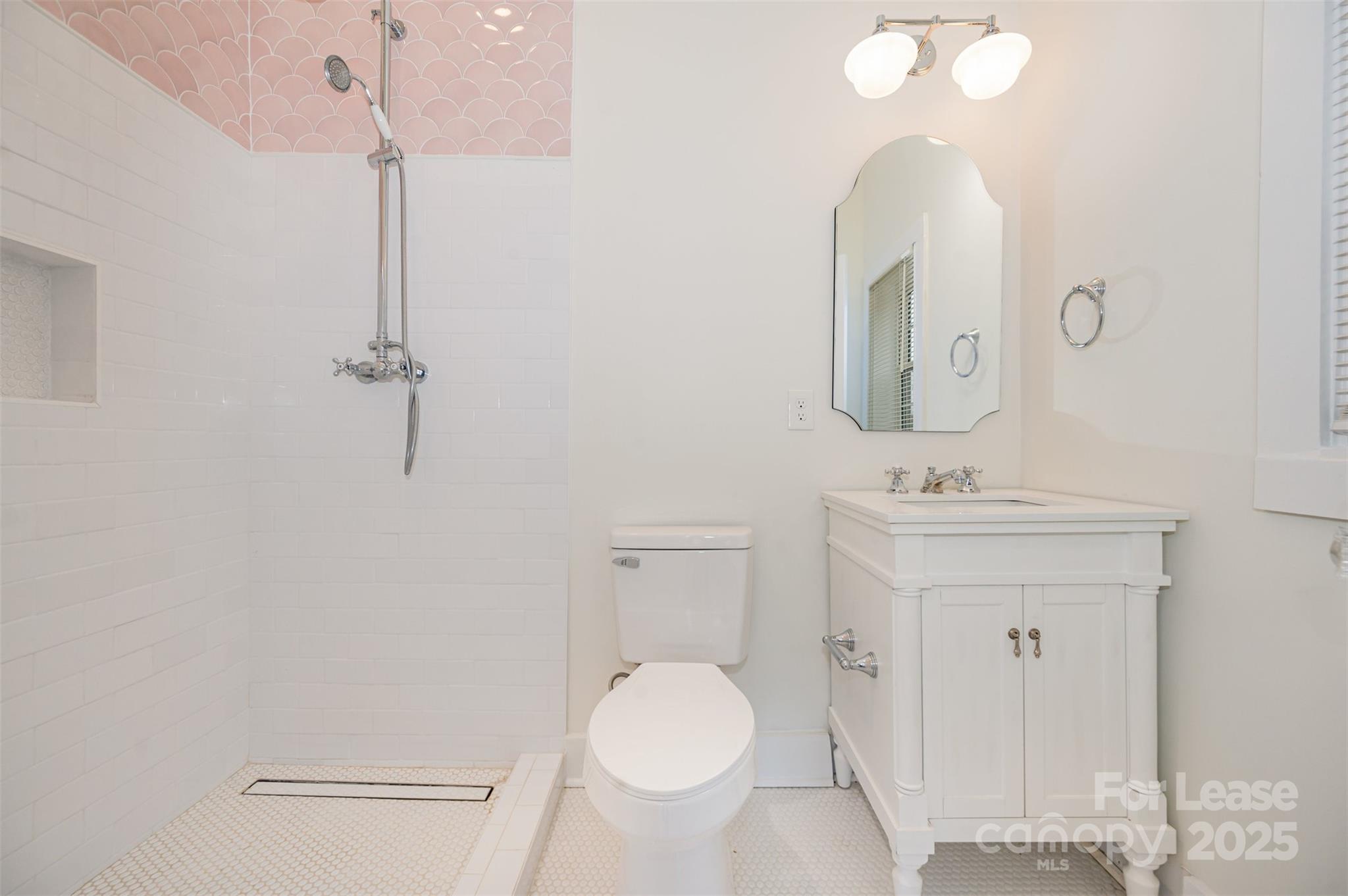3612 East Brief Road Monroe, NC 28110 - Photo 21 of 22 a bathroom with a toilet a sink and mirror