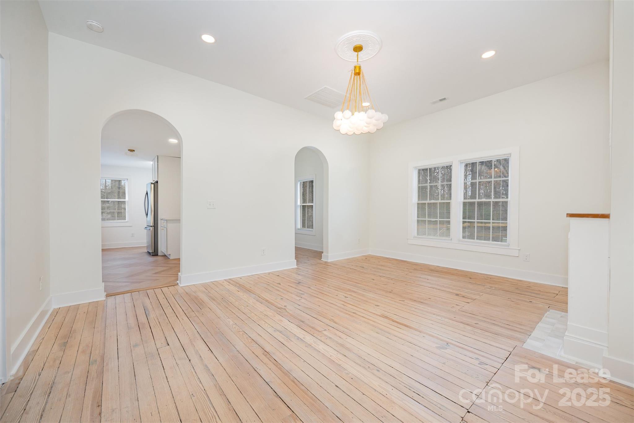3612 East Brief Road Monroe, NC 28110 - Photo 3 of 22 a view of empty room with wooden floor and window