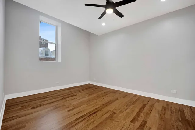 a view of a room with wooden floor and white walls