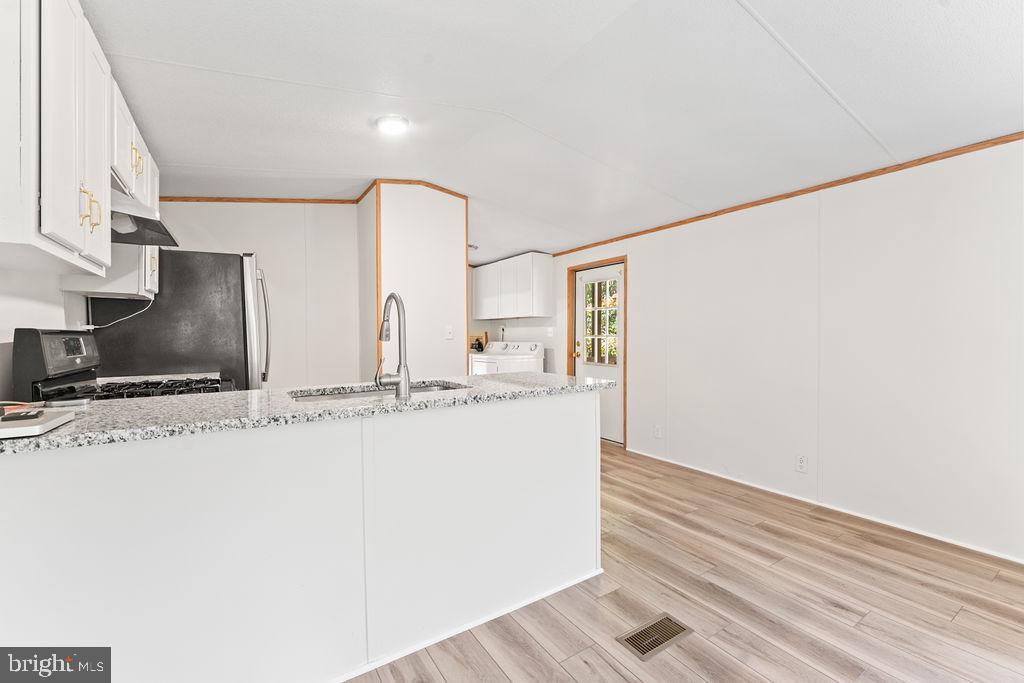 7227 Grand Brooks Road Spotsylvania, VA 22551 - Photo 10 of 47 Modern kitchen with sleek finishes.