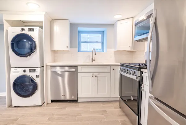 a kitchen with a washer and dryer in it