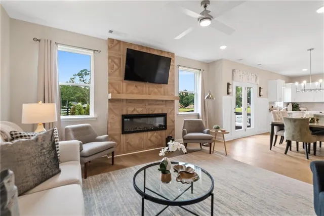 a view of a dining room with furniture a rug and wooden floor